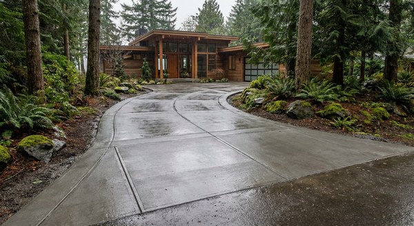 New broom-finish concrete driveway with crisp control joints and proper grade